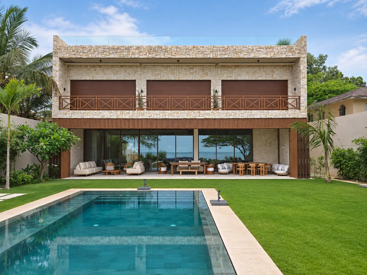 Façade arrière de la Villa Hoballah ouverte sur la piscine et la mer